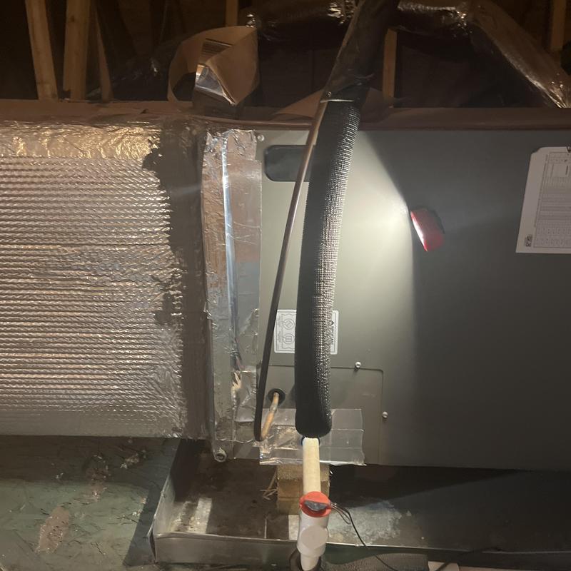 Air handler with foil tape on panel door in attic