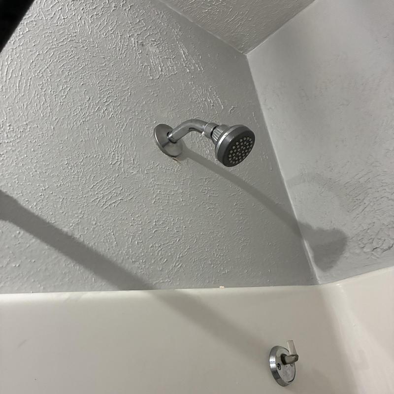 Shower arm and showerhead installation in bathroom corner Shower arm and showerhead installation in bathroom corner