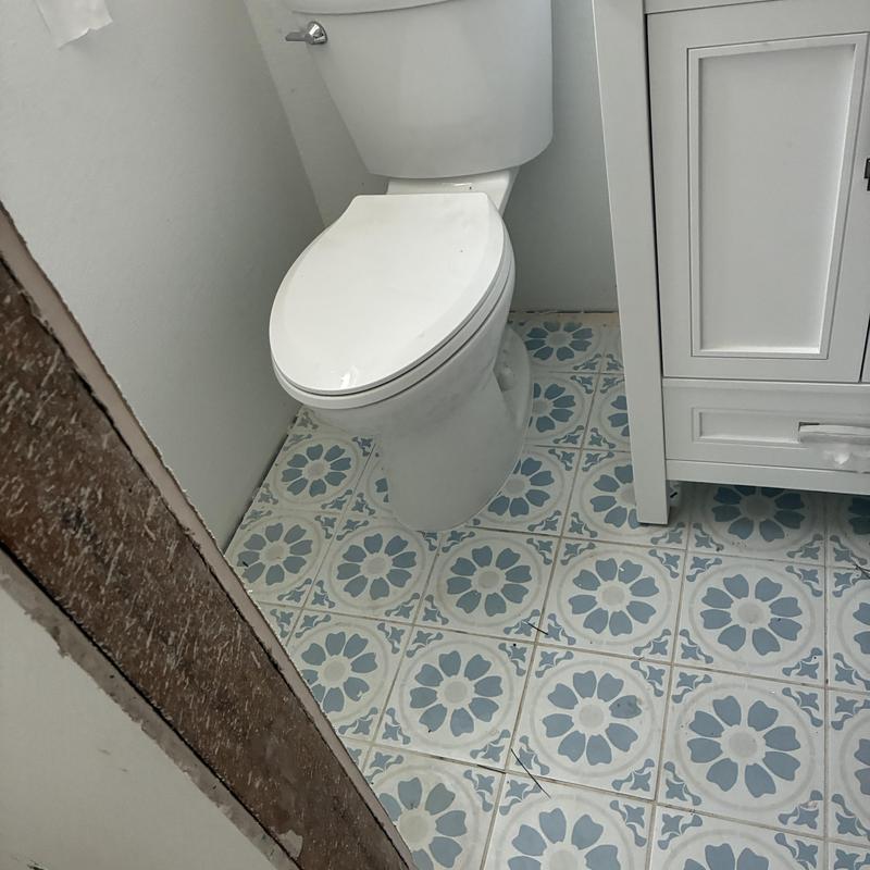 Toilet installation next to white bathroom vanity Toilet installation next to white bathroom vanity