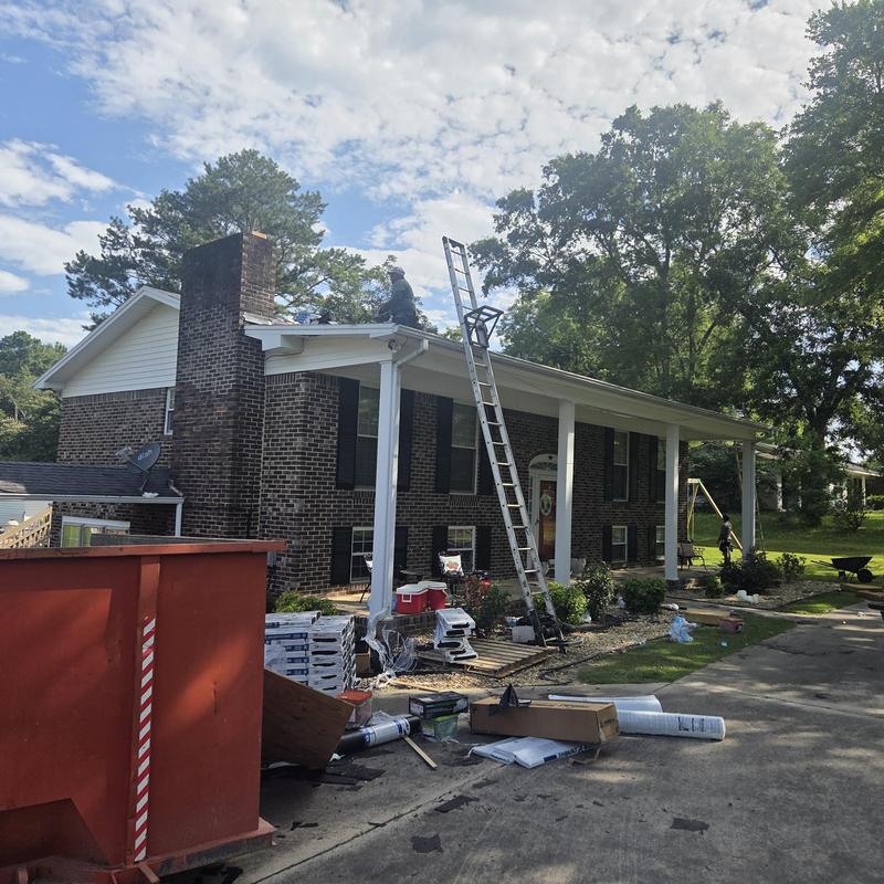 Asphalt shingle roof with ladder and equipment on site