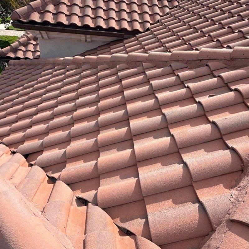 Tile roof with overlapping terracotta tiles in sunlight Tile roof with overlapping terracotta tiles in sunlight