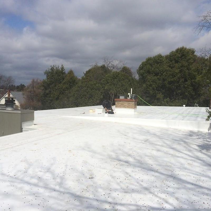 Flat roof membrane installation with technician working Flat roof membrane installation with technician working