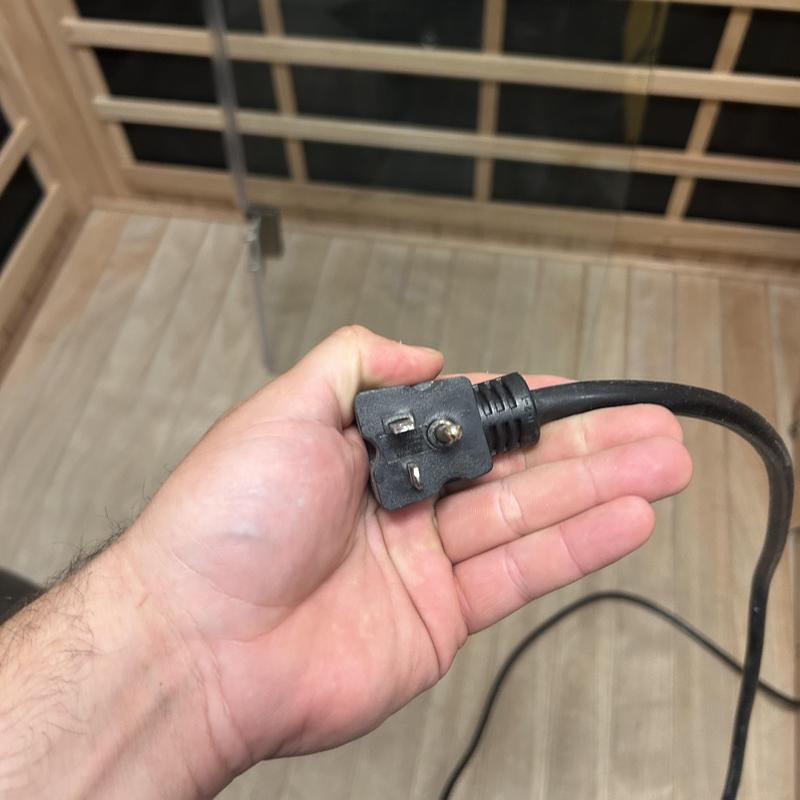 240V 20 amp GFCI power plug held in hand 240V 20 amp GFCI power plug held in hand