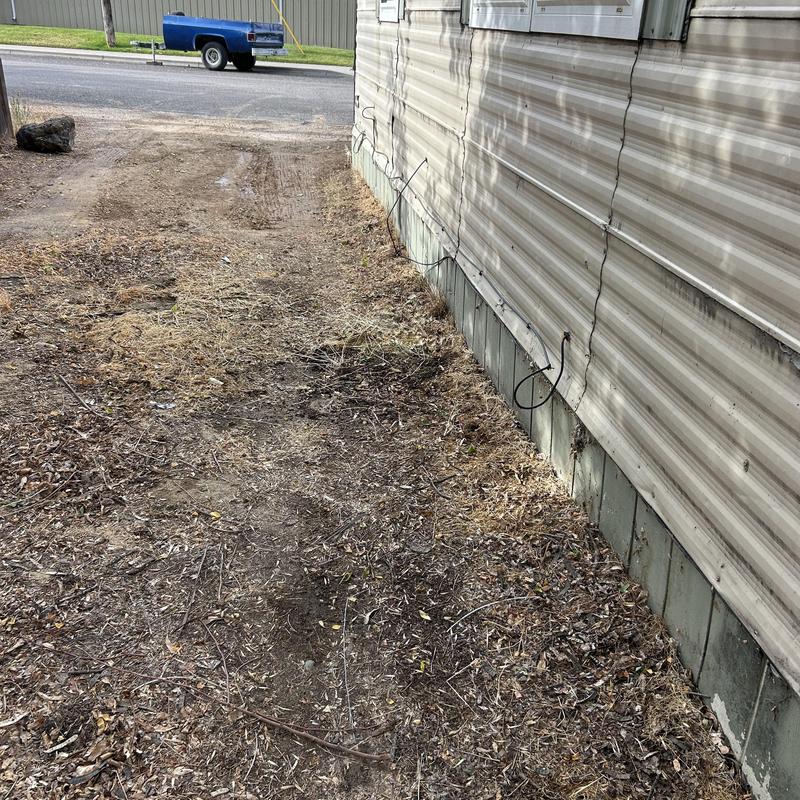 Waterline trench along mobile home exterior wall Waterline trench along mobile home exterior wall