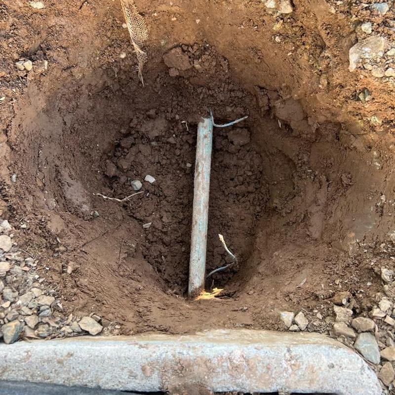 Main water line exposed in excavation hole