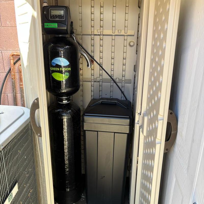 Green Fusion water softener system in shed installation