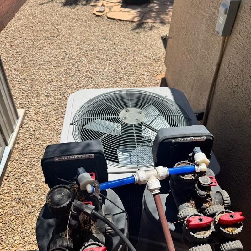 Water softener valves and piping on outdoor unit