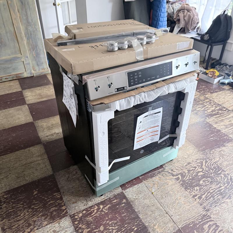 Gas range in packaging for installation in kitchen Gas range in packaging for installation in kitchen
