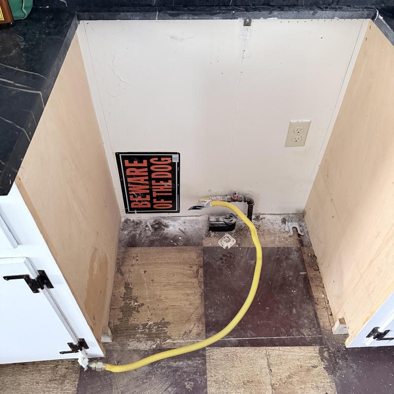 Gas range hookup with flexible yellow gas line installed Gas range hookup with flexible yellow gas line installed