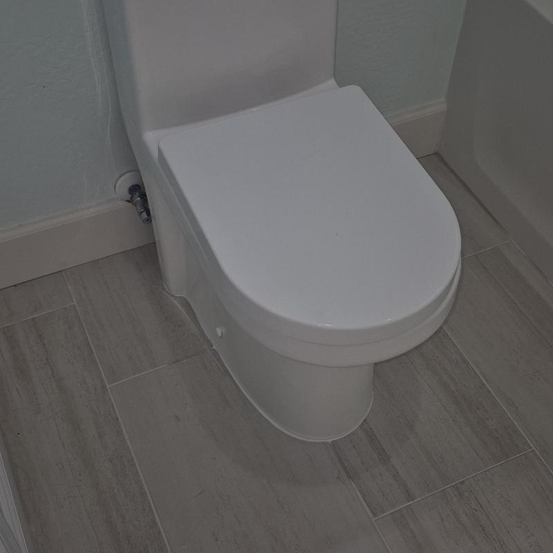 Toilet installation with modern floor tile in bathroom