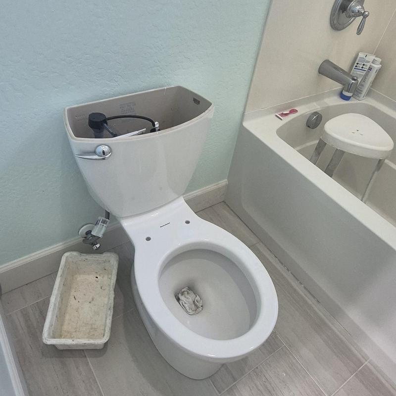 Toilet tank and bowl installation in bathroom