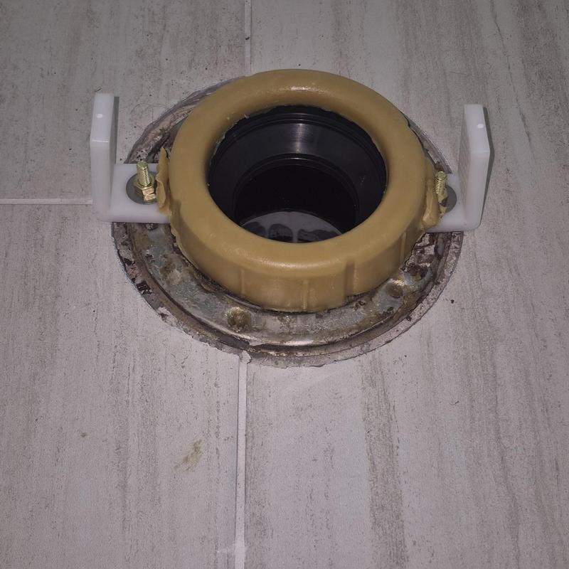 Toilet flange installation on tiled floor