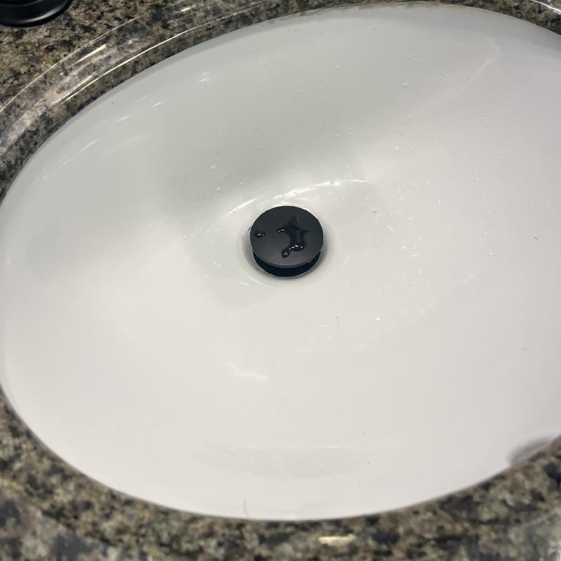 Click clack sink drain installed in white basin Click clack sink drain installed in white basin