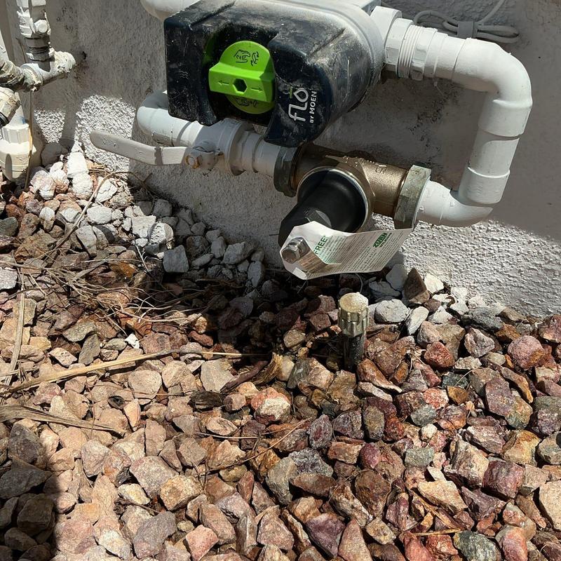 Pressure regulator and gaskets installed on outdoor plumbing line