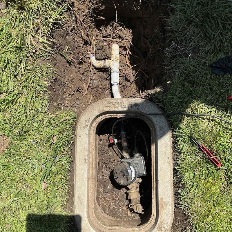 Water service line with exposed pipe and meter