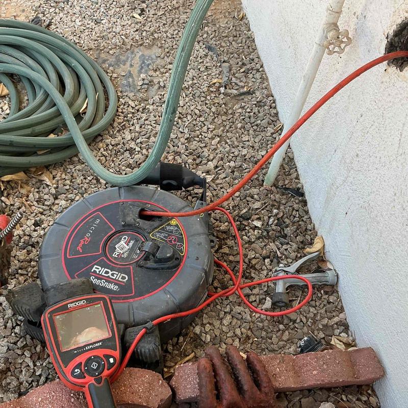 Drain cleanout with snake and inspection camera tools