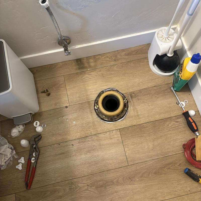 Toilet flange and wax ring on wood floor installation site