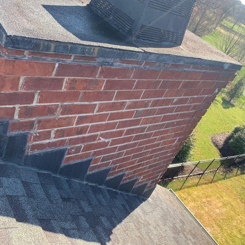 Roof shingles and brick chimney flashing inspection
