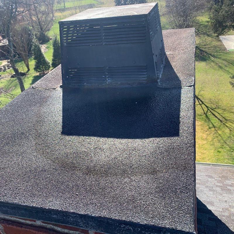 Flat roof surface with vent pipe flashing repair
