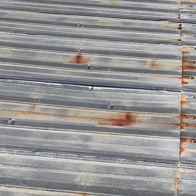 Metal roofing panels with hail dents and rust spots