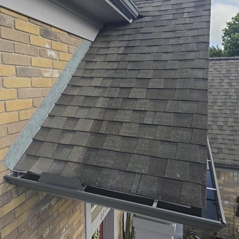 Architectural shingle roof with minor wear and exposed fasteners