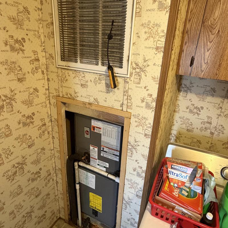 Indoor furnace and HVAC unit in laundry room niche Indoor furnace and HVAC unit in laundry room niche