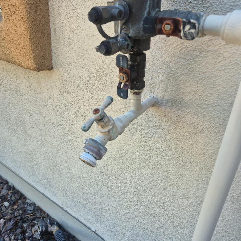 Outdoor hose bib with shutoff valve on stucco wall