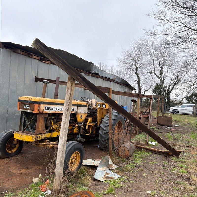 Barn metal roofing with hail damage and debris
