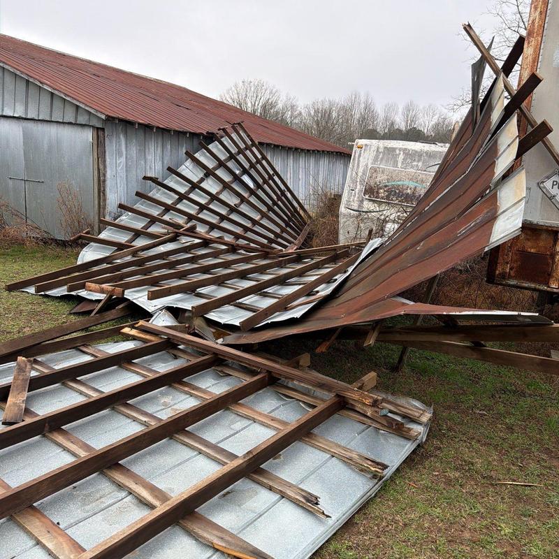 Barn metal roofing panels collapsed on ground