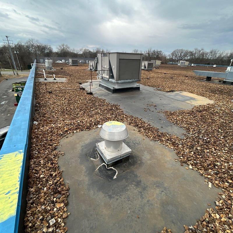 Roof vent with cracked roofing membrane and gravel rooftop