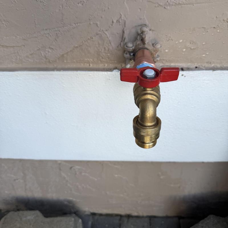 Outside hose bib with red handle valve installed