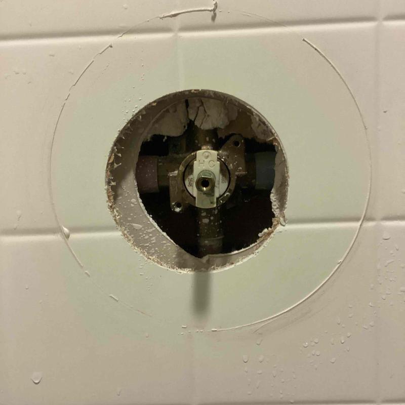 Shower cartridge valve exposed in tiled wall cavity