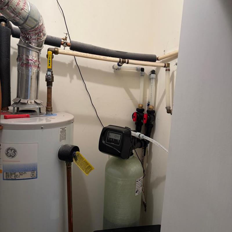 Water softener system installation with pipes
