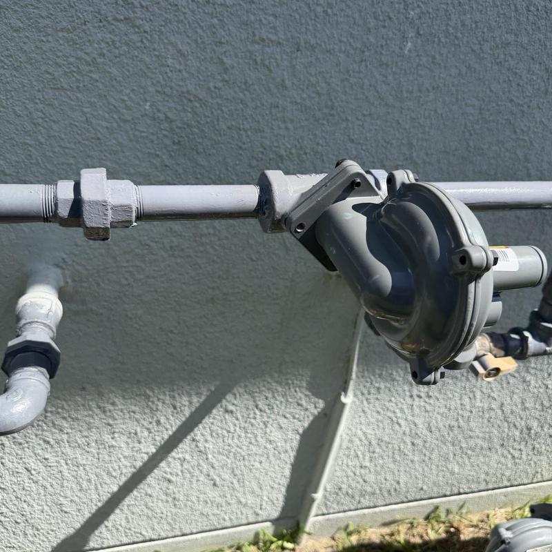 Gas regulator with connected piping installed on wall