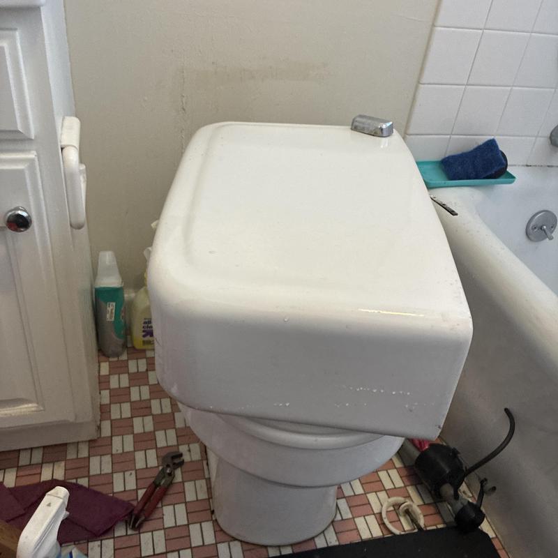 Toilet tank replacement and leak repair in bathroom