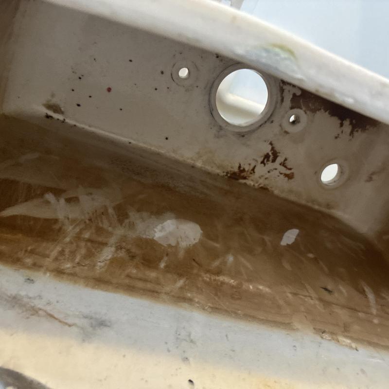 Toilet tank interior with rust and stains