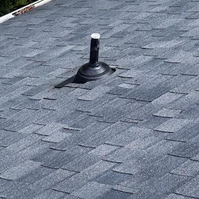 Roof vent flashing with sealed shingles on asphalt roof