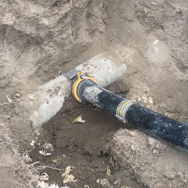Tap riser and clean out pipe with repair clamps in dirt Tap riser and clean out pipe with repair clamps in dirt