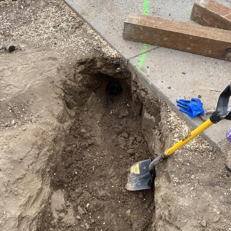 City sewer main exposed with shovel and excavation tools City sewer main exposed with shovel and excavation tools