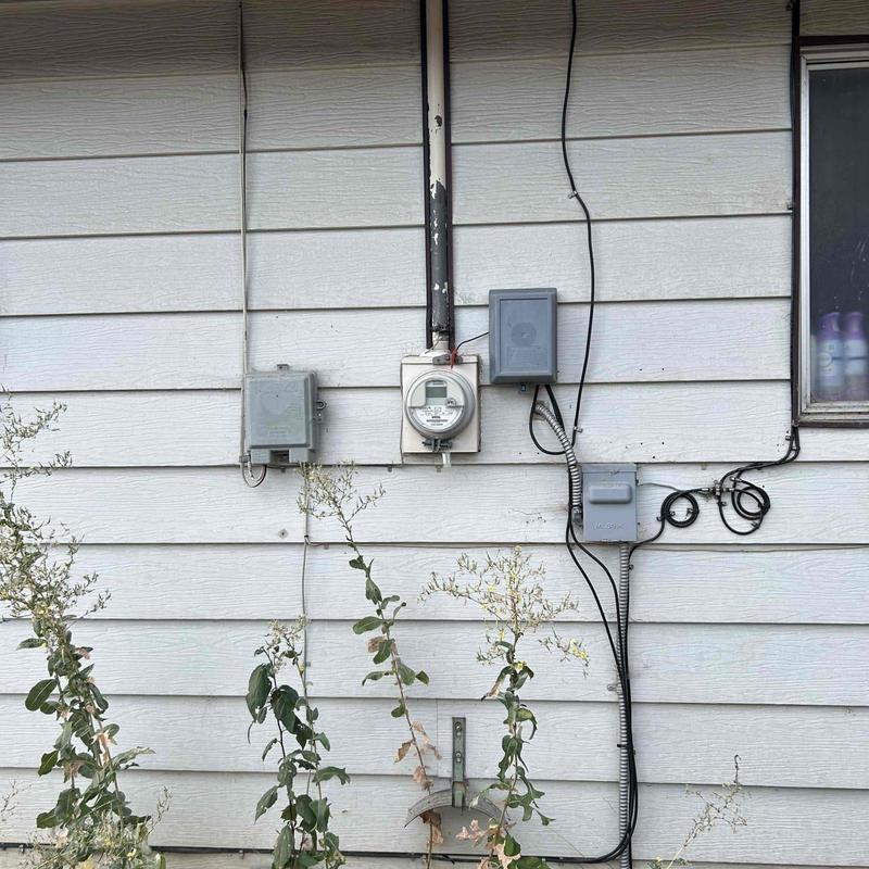 Electric meter and conduit installation on house exterior Electric meter and conduit installation on house exterior