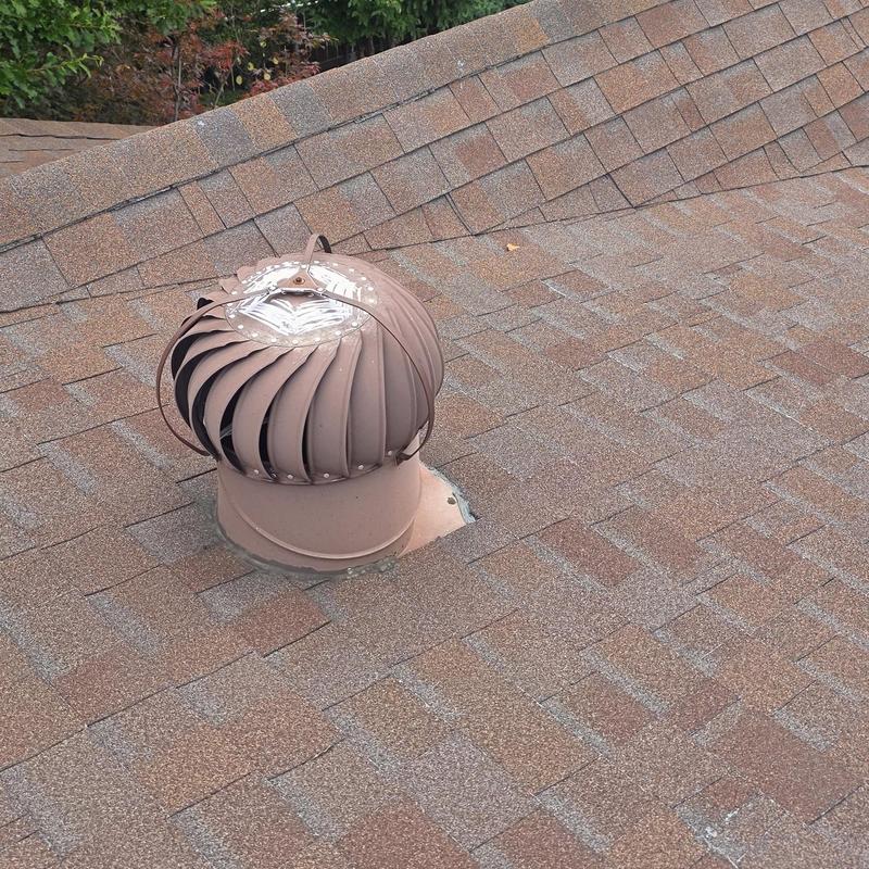 Roof turbine vent with hail damage on shingles