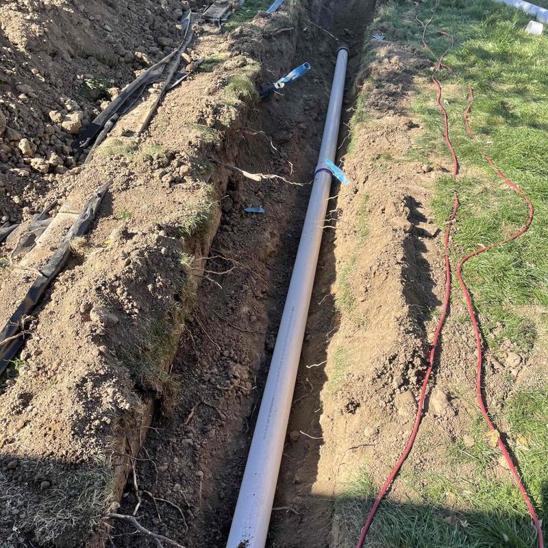 PVC sewer pipe replacement trench with exposed pipe PVC sewer pipe replacement trench with exposed pipe