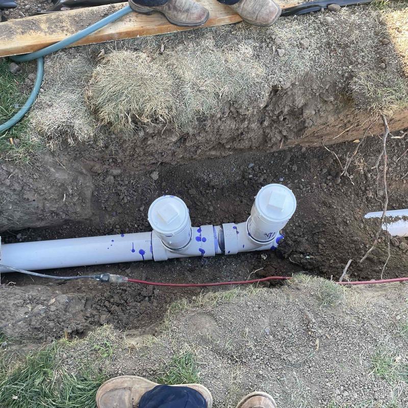 PVC sewer line with cleanouts exposed in trench PVC sewer line with cleanouts exposed in trench