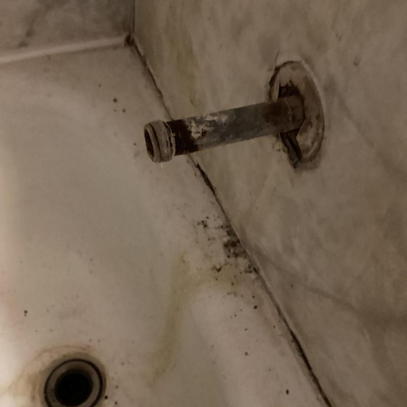 Tub spout nipple with corrosion and water damage in tub Tub spout nipple with corrosion and water damage in tub