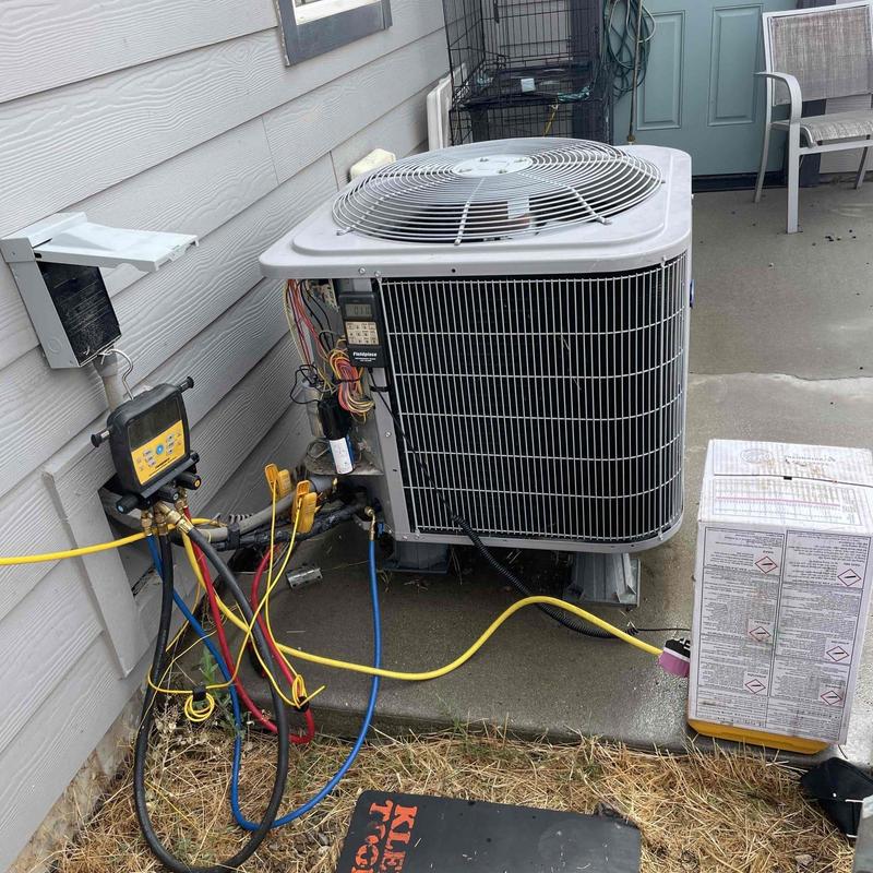 Heat pump AC unit with refrigerant gauges connected Heat pump AC unit with refrigerant gauges connected