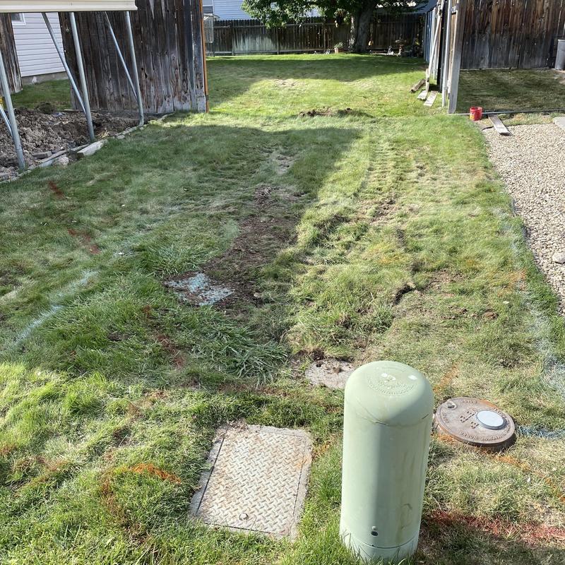 Water main excavation site with meter and trench marks Water main excavation site with meter and trench marks