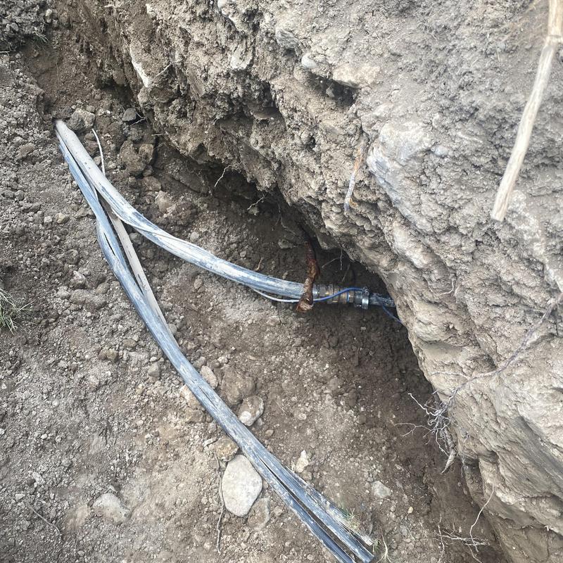 Water main excavation and bypass cable installation in trench Water main excavation and bypass cable installation in trench