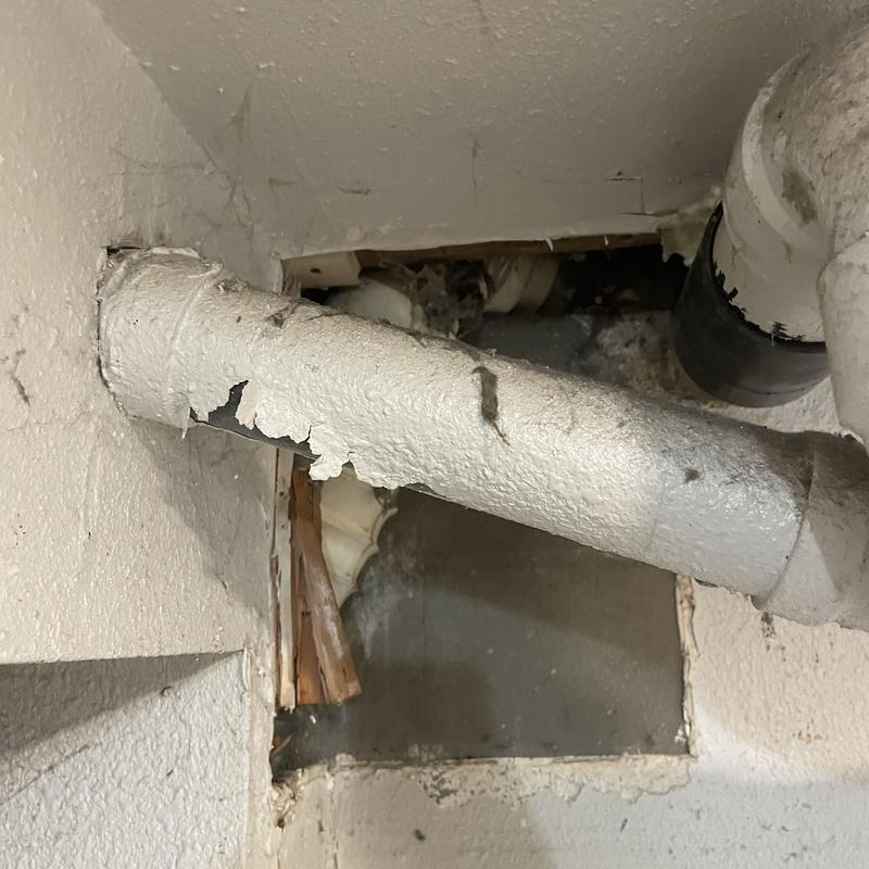Toilet drain pipe and flange access cut in wall Toilet drain pipe and flange access cut in wall