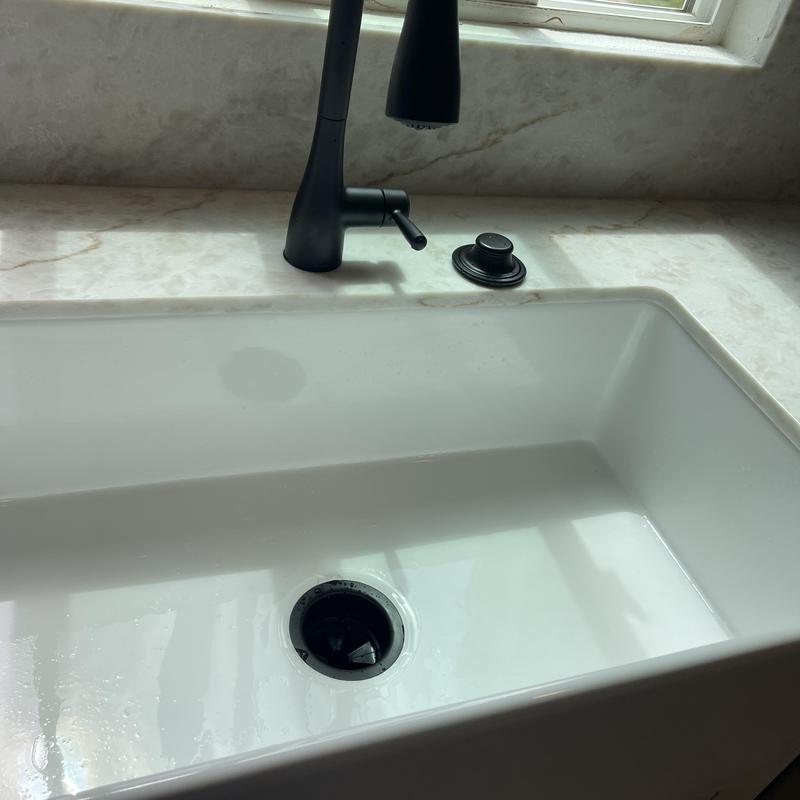 Kitchen faucet and white sink with soap dispenser