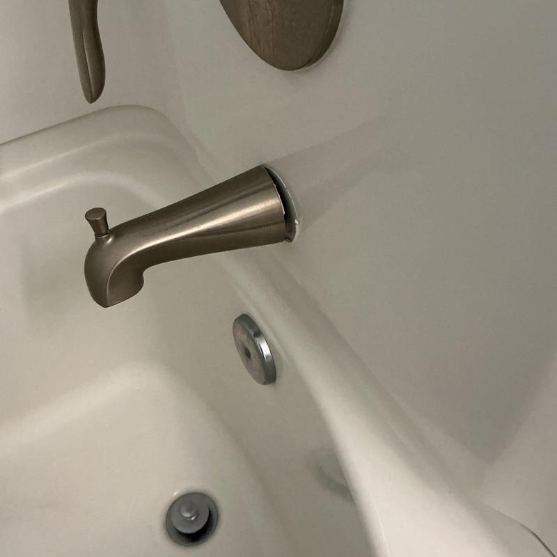 Faucet diverter spout on bathtub wall